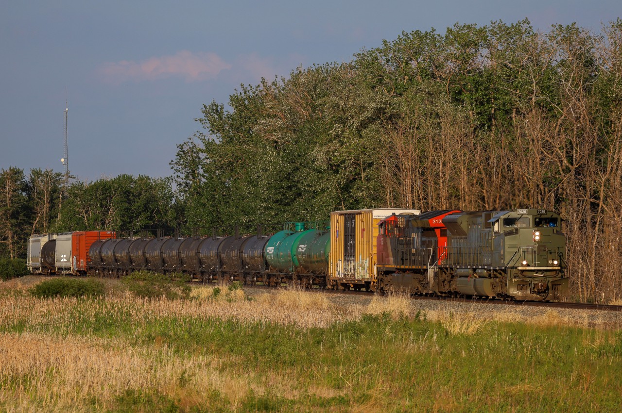 CPKC Edmonton to Scotford B82-04 is on the approach to Scotford Yard with CP 7020 and CN 3128.
