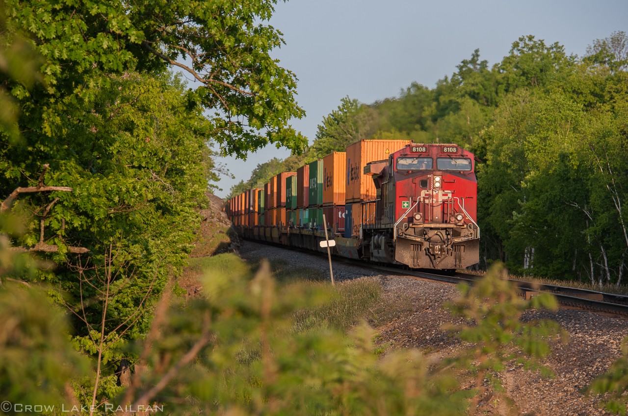 CP 113's tail end dpu finds some early morning light at Crow Lake at the end of May. The train is just a couple hours into it's cross country trip from Montreal to Vancouver. Next stop Toronto!