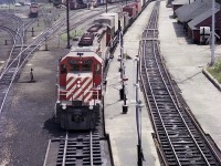 Decent view of the old yard at Chapleau from 1977 showing various MoW equipment and rolling stock as well as a couple of locos. On the right is a freight building, a former station and a new modern station (flat roof) in behind.  Westbound CP 5530 and 5542 about to leave the Nemegos Sub for the White River sub after a crew change.
Photo taken from overhead walk bridge.