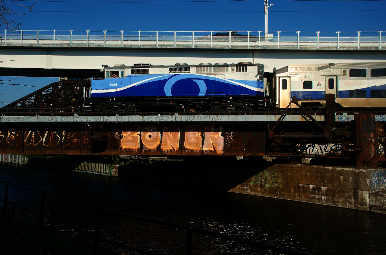 A crewmember gives the peace sign as a deadhead move crosses the Lachine Canal during the morning rush hour.