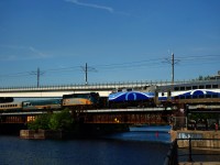 VIA 6448 & EXO 1346 are about to pass each other as they cross the Lachine Canal. VIA 6448 is leading VIA 22 towards Central Station and EXO 1346 is leading a deadhead move going in the opposite direction.