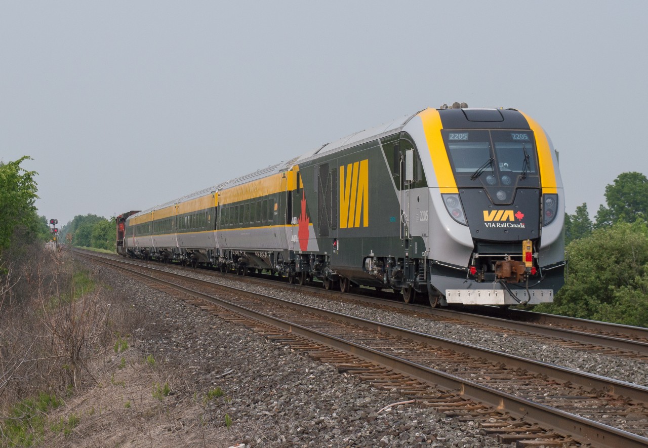 CN P276 flies by Powerline Road West outside of Brantford with a new Siemens set trailing a SD70M-2 under smoky skies.