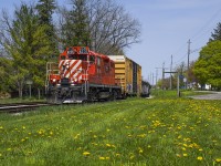 A fine spring day finds OSR 8235 on the Woodstock Job returning west towards Ingersoll.  A number of cars loaded with steel beams will be left here in the Beachville siding for later delivery to the Ingersoll transload near CAMI.