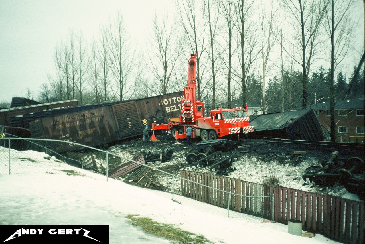 CP crews work to clear a big derailment that happened between Galt station on the Galt Subdivision and the curves before the westbound Orrs Lake mile sign in winter 1986. The photo was taken with permission from the homeowner whose property backed onto the line. I don’t know much about the derailment itself, so any further information is appreciated.