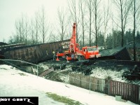 CP crews work to clear a big derailment that happened between Galt station on the Galt Subdivision and the curves before the westbound Orrs Lake mile sign in winter 1986. The photo was taken with permission from the homeowner whose property backed onto the line. I don’t know much about the derailment itself, so any further information is appreciated. 