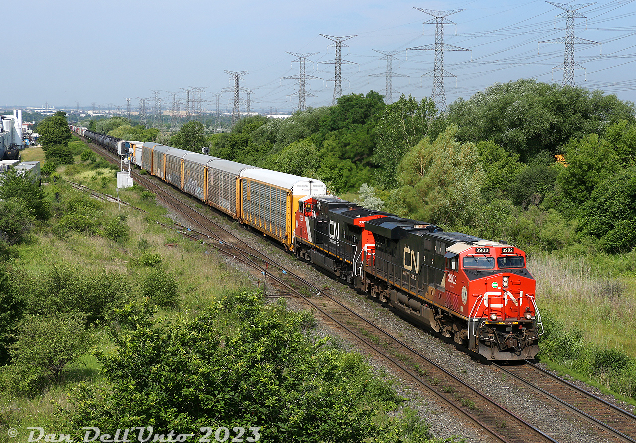 Not a bad late morning for CN action near MacMillan Yard: CN ES44AC 3902 and AC44C6M (rebuilt C44-9W) 3323 lead an eastbound freight over the Humber River bridge, about to duck under the underpass at Weston Road. An westbound intermodal for Brampton Intermodal Terminal would soon pass by once the Humber was clear, followed by another eastbound freight yarding into MacMillan Yard, and an eastbound intermodal departing out of BIT.