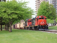 GP38-2s 4719 and 7502 push a string of covered hoppers through Sarnia's downtown Centennial Park to the Cargill elevator facility at Sarnia Harbour on a rare Sunday evening run on the Point Edward Spur.