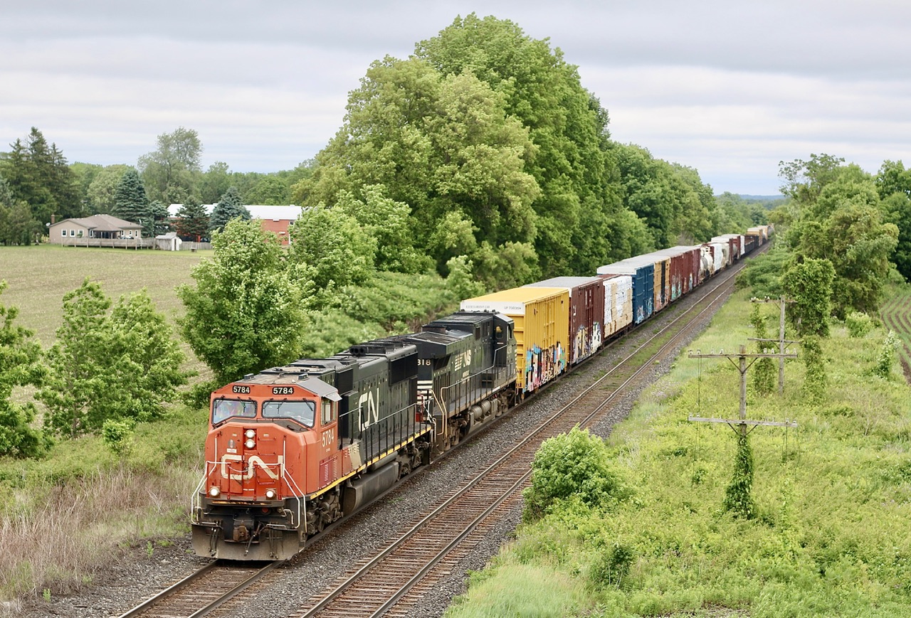 This is one of those few spots along the Dundas subdivision that I somehow never took advantage of years ago. This shot is somewhat similar to what you used to be able to do at the highway bridge at Creditville before it all grew in.  Up until a few years ago there was an old steel road bridge here, it was later removed and rebuilt with a new steel structure, for whatever read the bridge sat unopened for quite sometime until it was finally opened in late 2022. The location here is known as Etonia and is just west of Paris. One of the more exciting CN trains out in the road these days is CN train 397 and this day was no different with a NS unit trailing and a SD75 up front. I think I get more excited these days when a SD75 shows up in the lead then when I first saw them brand new, although anything not GE in the lead is worth getting excited about, LOL.