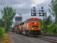 On June 7, 2023, QG 501 is made up of two ex-BNSF SD70MACs as well as 57 wagons from different industries served by the shortline. The train is seen here taking the switch that will take it north of the CPKC St-Luc yard.