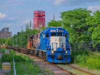 On June 20, 2023, CN 596 has just dropped off various cars at the Port. It is now returning with an empty double-stack train heading for Pointe-Saint-Charles.