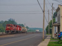 On June 25, 2023, CPKC G20 has just dropped off two grain cars in Farnham Yard and is now preparing to store the rest of its train further north at Mile 8 of the Adirondack Subdivision.