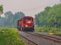 On June 25, 2023, CPKC G20 has just deposited the rest of its train on the siding just north of Farnham Yard, where the cars will be picked up by CPKC 121 in the evening. The light power now returns to Sherbrooke where the crew will have finished their day.