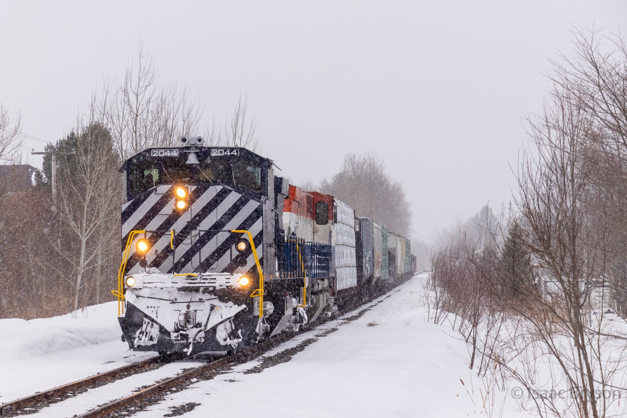 After 2 hours work at the industrial park in Saint-Lambert-de-Lauzon QC, CFS has 12 cars bound for interchange in CN's Joffre yard (Levis QC). They roll through a small rural Quebec town where a friendly local questioned my presence with the camera by the tracks in her little town. CFS 2044 and 2047 are Ex OSR nee BCOL M420Ws that I've been interested in shooting for years. This short chase definitely satisfied those desires.