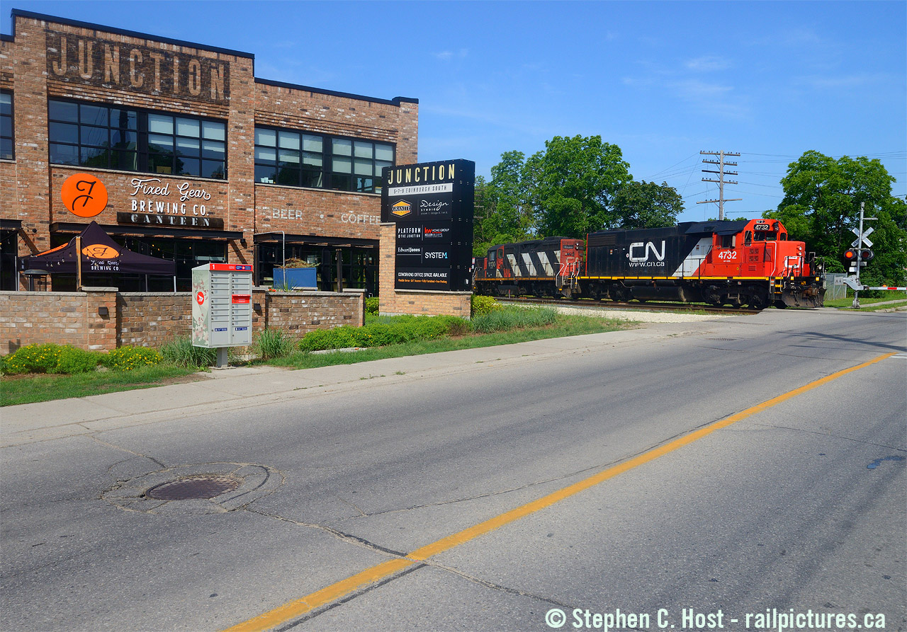 CN L540 passing the Fixed Gear brewery and pub on Edinburgh Road at the "Junction" Neighbourhood. Known as CN Guelph Junction Wellington, this Granite Homes development has embraced their railway roots with gusto, complete with a caboose and other railway items on site. The food and drink is great as is the view of about 30 train movements daily. Visit soon!