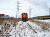 We're at the very end of track of the N&NW Spur (former H&NW Railway) and infrastructure is everywhere. Framed between highways, transportation, electricity and pollution is the 7524, a yard unit with temporary ditch lights. <a href= http://www.railpictures.ca/?attachment_id=18993 target=_blank>I did something similar 8 years ago</a> and that too would get a bumper not long after. The 0700 is using almost all of what remains of the N&NW to pull empties from Parkdale Warehousing before spotting the loads. The fresh snow kind of hides the grit of Hamilton, in a way, but down here you really can't hide it. It's everywhere.