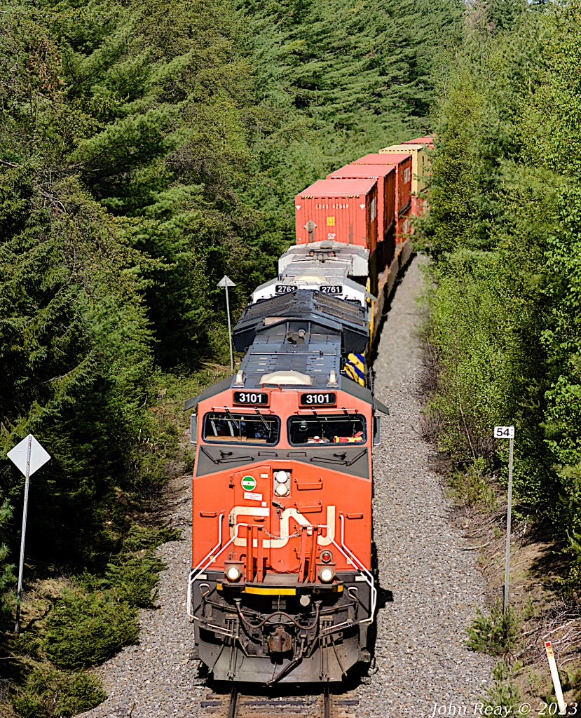 Seen here is the head-end of CN Z120 on May 31st 2023, going under the highway 142 overpass at Salt Springs NS with CN 3101 and CN (ex-CREX) 2761 and 534 axles (DPU CN 3020 is mid-train.) This was part of a day out with Halifax area railfan Geoff Doane where we chased this train from the New Brunswick border close to 140 km to south of Truro. In that distance we shot this train six times then had lunch in Truro and lucked into an encounter with CBNS train 305 arriving in the yard there, and finally shot CN L507 five times starting at this trestle all the way to Painsec Junction just a few kms short of Moncton NB.