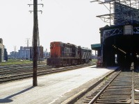 The sun is high in Toronto in June 1970. CN 3106 and an unknown CN MLW FPB-4 are seen near Toronto Union Station.