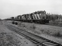 Right on the border between Alberta and Northwest Territories at mileage 300.4 on the Meander River sub. of CN’s Great Slave Lake division, northward symbol train 875 on Saturday 1978-09-23 had two GP9s and an SW1200RS, CN 4341 + 4351 + 1376, for power as it crossed latitude 60 degrees north at 1141 MDT.  Last station was Indian Cabins, AB, at mileage 291.3, next is Grumbler, NWT, at 311.3