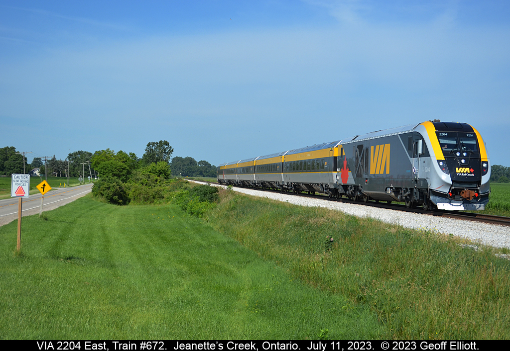 The future is coming quickly despite the sign that says "Caution.  Slow moving vehicles".  VIA 2204, one of the new Siemen's train sets, heads east on the VIA Chatham Subdivision during another test run on July 11th, 2023.  Soon these will be the 'norm' on the Toronto/Windsor corridor displacing all the P42's and F40's that we've been accustomed to for so many years.   Get your shots of the old power and consists before these take over forever.....