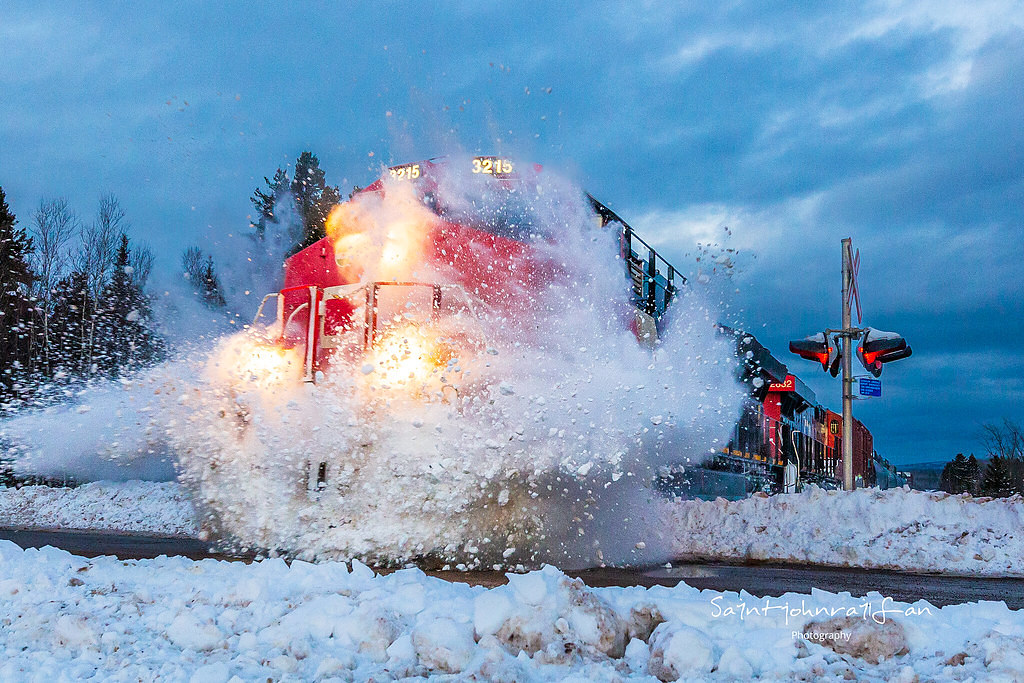 The day after a winter storm hit the area with heavy snow and freezing rain, CN train 594 cruises along and hits a snowbank at Passekeag, New Brunswick. Not the biggest poof I've gotten, but I'll take it.