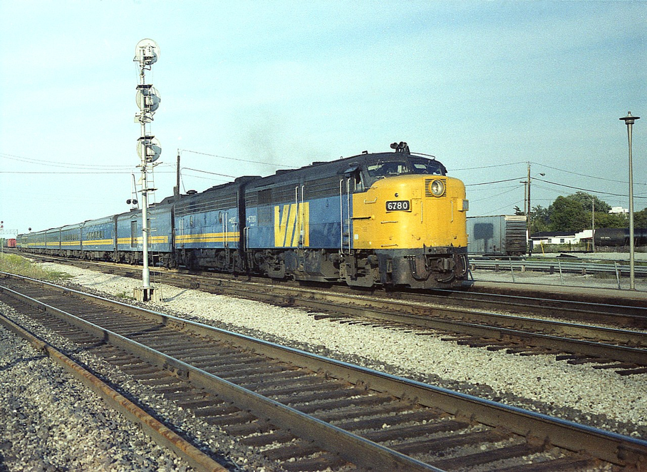 At what was once a favourite location for shooting VIAs, because they stopped at Burlington West's old Freeman station; here is an image of dinner-hour train #79. It usually was a bit smaller than the #75 that was the premier westbound of the day, but this is pretty good as well.  VIA 6780, 6627 waiting out passengers on a really nice early evening many years ago.  The 6780; she has been preserved, still running on the Cuyahoga Valley based in Independence, Ohio.