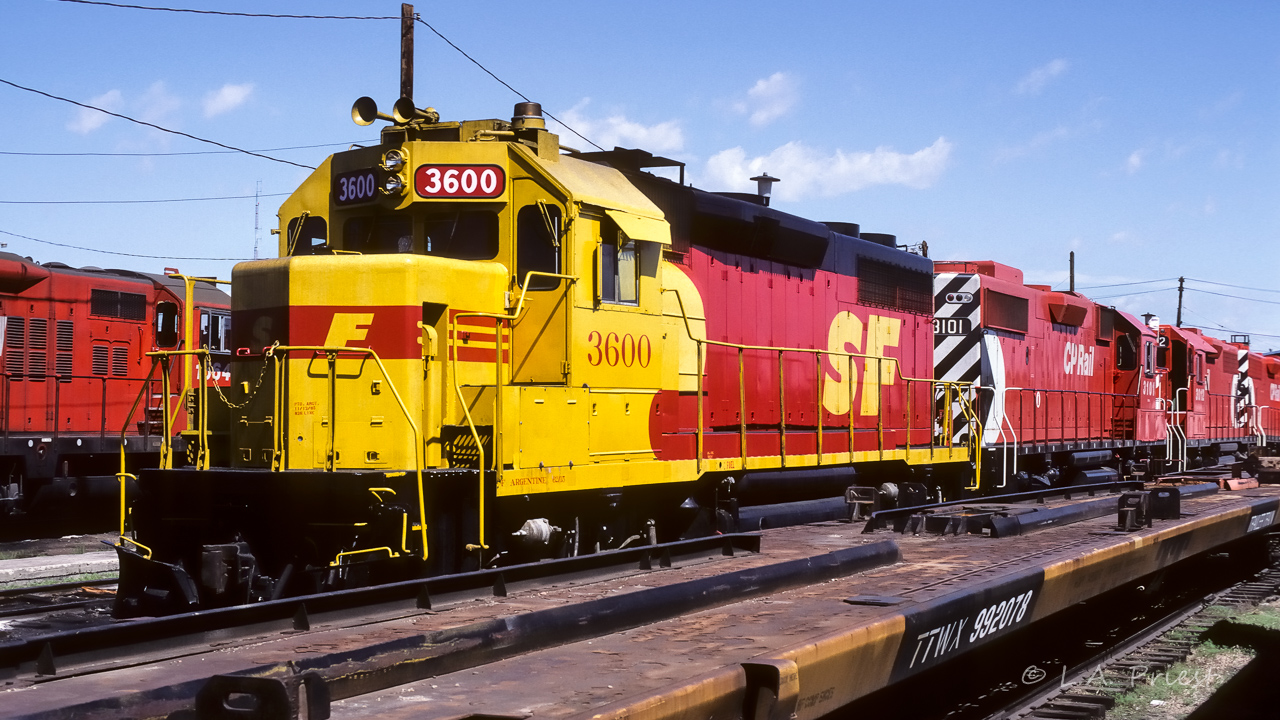 Before returning back to Redwater on a visit to Edmonton, I took a quick look at the CP South Ed. diesel shops and found this. I am putting this photo in connection with Jacob's Agincourt Diesel Shop post from Jan/88. He mentioned the ATSF 3600, which brought me to this picture from the summer of 1987. The 3600 is paired with CP 3101. Behind are another pair the 3012 with an unknown GP38. To the left is CP 1564. SF 3600 has the name Argentine placed between the F and the 62/15 on the side of the frame. If there is a favourable way to have cars parked in front of the units, I hope this is it. :^)