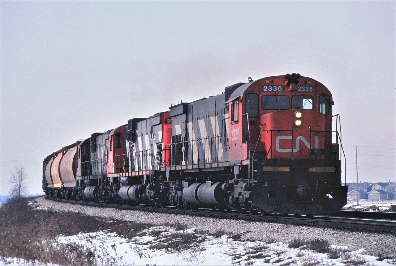 A trio of big MLW units lead an eastbound freight on the York Sub just east of Bathurst Street on February 15, 1981.  Units are 2335, 2004, and 2011.
