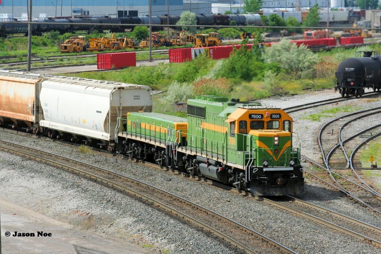 While photographing trains arriving and departing from CN's MacMillan Yard in Vaughan, Ontario just north of Toronto, I happened to look over and almost missed CN 7600 and 600 quietly heading towards the west end of the yard with a cut of cars. I was able to snap a few frames from the Highway #7 overpass as they went by, reversed, and disappeared back into the yard all within two minutes.
