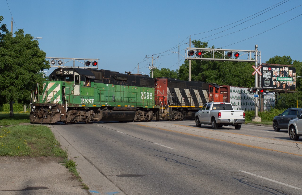 CN L580 makes its way across Colborne Street in Cainsville on the beginning of their trip down the Hagersville Subdivision behind BNSF 2098 and CN 9547.