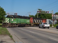 CN L580 makes its way across Colborne Street in Cainsville on the beginning of their trip down the Hagersville Subdivision behind BNSF 2098 and CN 9547.