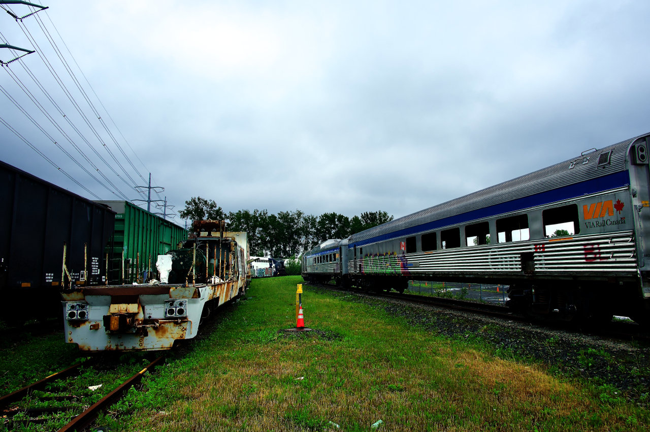 Sacrificed for structural testing, derelict VIA Rail equipment sits at CAD. At left is more ex-VIA Rail equipment - a testbed built on an LRC-3 frame.