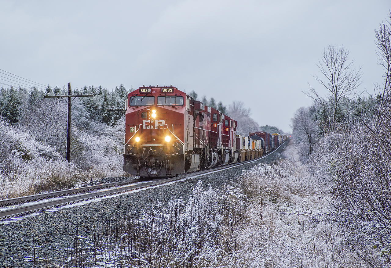 Screaming west with a heavy train, four units lead 135 along the Galt Sub after the first snowfall of the season.