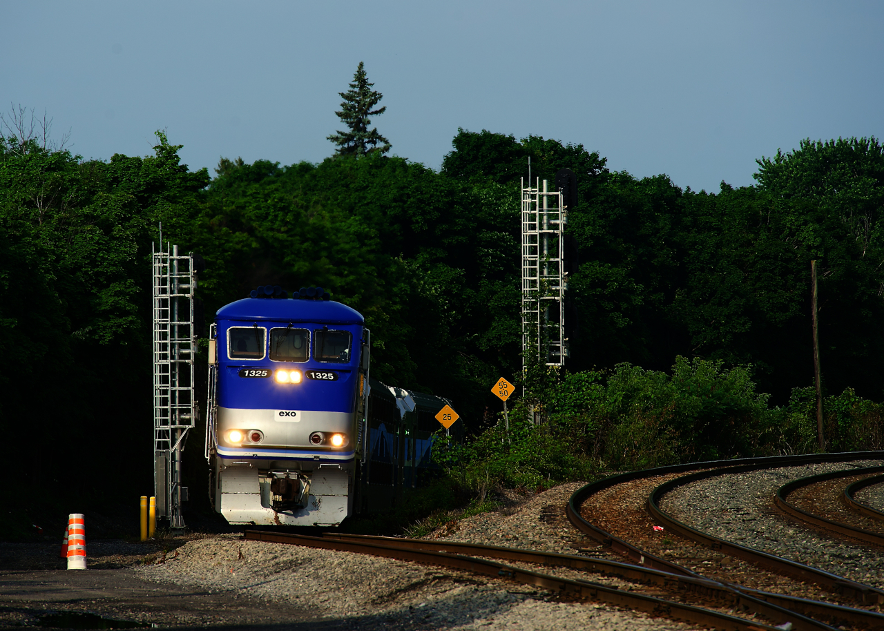EXO 78 from Candiac is approaching Montreal West tower and station with EXO 1325 and three multilevel cars.