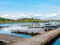 Boats are seen resting along one of the many docks lining Portage Bay on gorgeous Lake of the Woods in downtown Keewatin. The peace and serenity of the scene is broken by the reverberation of westbound train 119-16, skirting the man made shoreline. Having just received their results of their outbound pull by inspection at the crew change point in Kenora, the crew is getting the train up to track speed. Along their journey they will see a pair of back to back eastbound hotshots (100-16 and 118-16) somewhere in the middle of the Keewatin Sub before proceeding onto Winnipeg to essentially set off half their train and lift just as much traffic west for Edmonton.