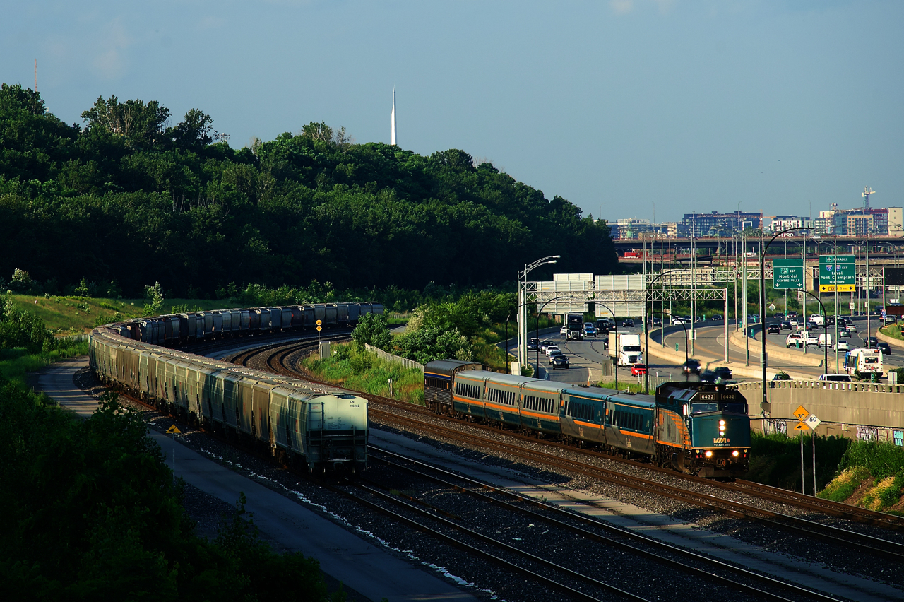 VIA 669 passes parked grain cars as it heads west. It has a single stainless steel car on its tail end, a common sight on VIA corridor trains recently.