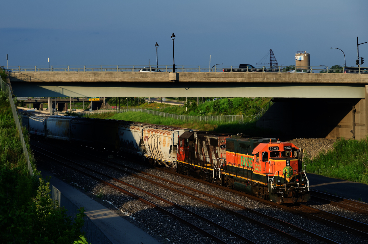 In a surprising development, a number of BNSF Geeps are in local service on CN, apparently repaying horsepower hours. Here BNSF 2302 leads CN 596 as it crosses over from the Freight Track to the North Track at Turcot Ouest with traffic for Taschereau Yard.
