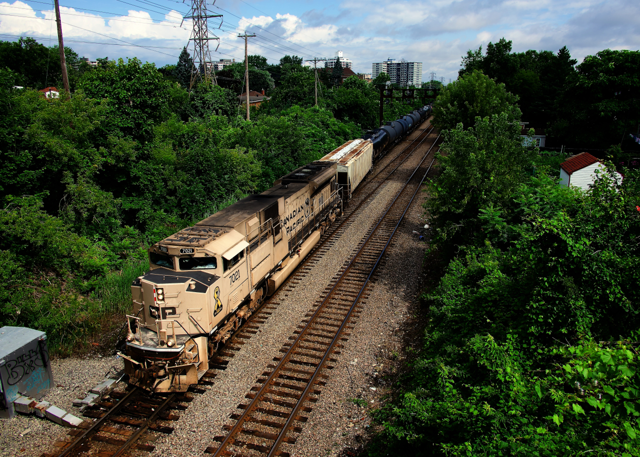 The sun pops out just after ethanol train CPKC 528 has departed south with the American crew onboard. Leading is the desert military unit.