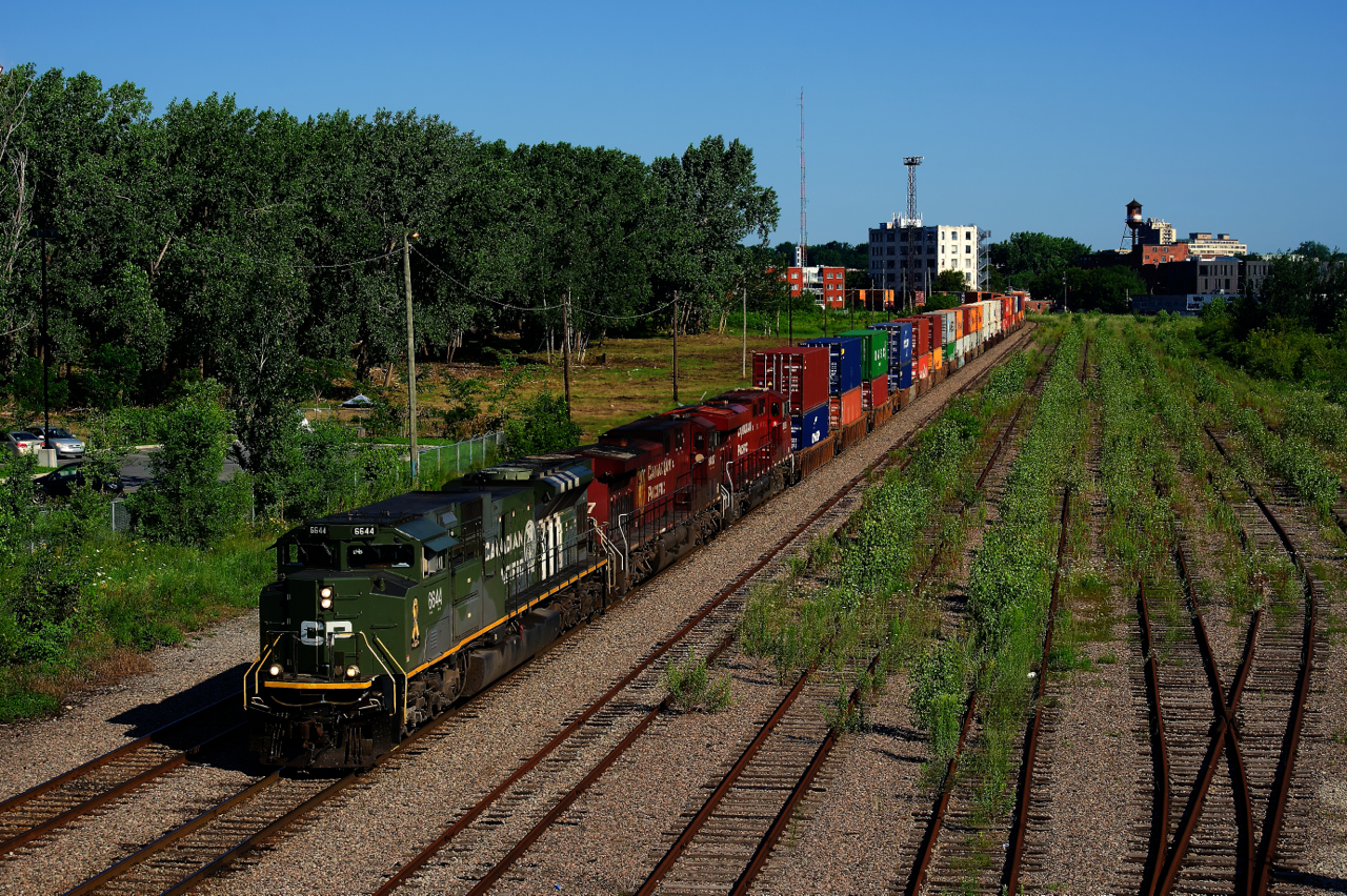 CP 6644 is leading on CPKC 118 as it passes the empty and overgrown Hochelaga Yard in East end Montreal. CP had a number of local clients around here as recently as the mid-2000s, but none are served by CP anymore. The train will soon enter the Port of Montreal, where the intermodal portion of this train terminates.