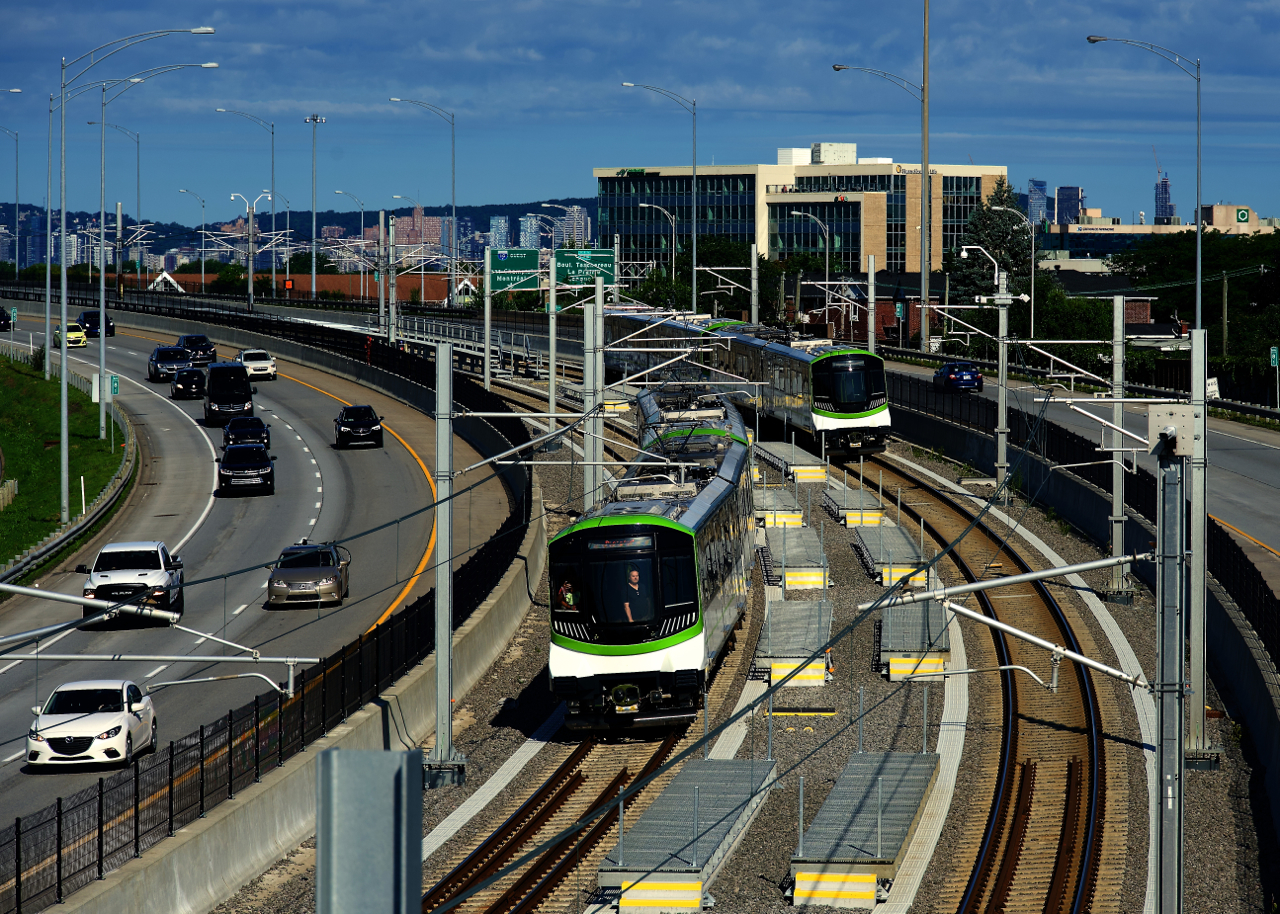 The REM light rail line opened between downtown Montreal and Brossard on the South Shore with free rides offered all weekend. Here two trains meet, with Autoroute 10 on either side and Mount Royal in the background.
