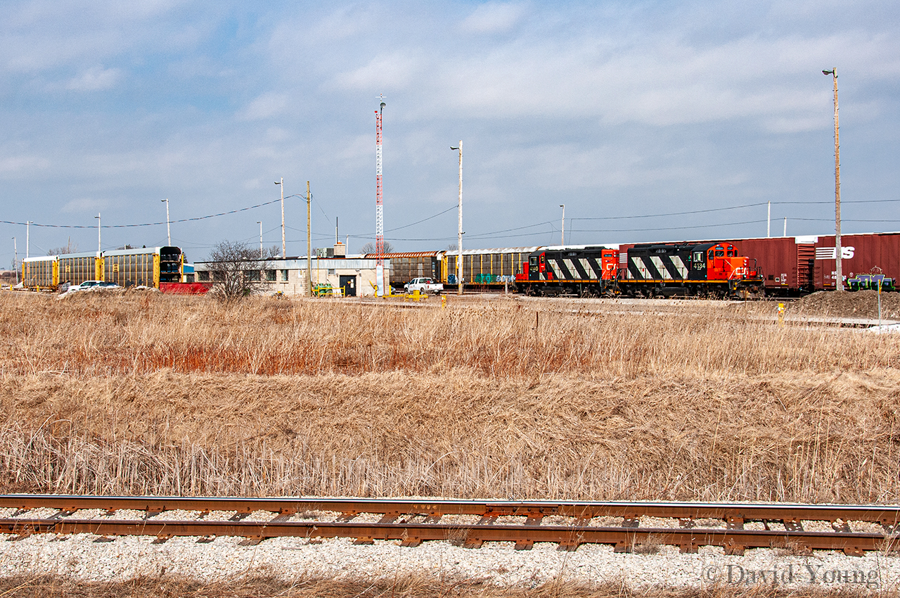 In September 2011 Ford would close their St Thomas assembly plant, ceasing 44 years of producing cars in Elgin County. A little more than two years prior to the closure, on a quiet Monday morning I found CN GP9RM's 4134-4140 resting outside the yard office at Talbotville awaiting their next call to service at the nearby plant.