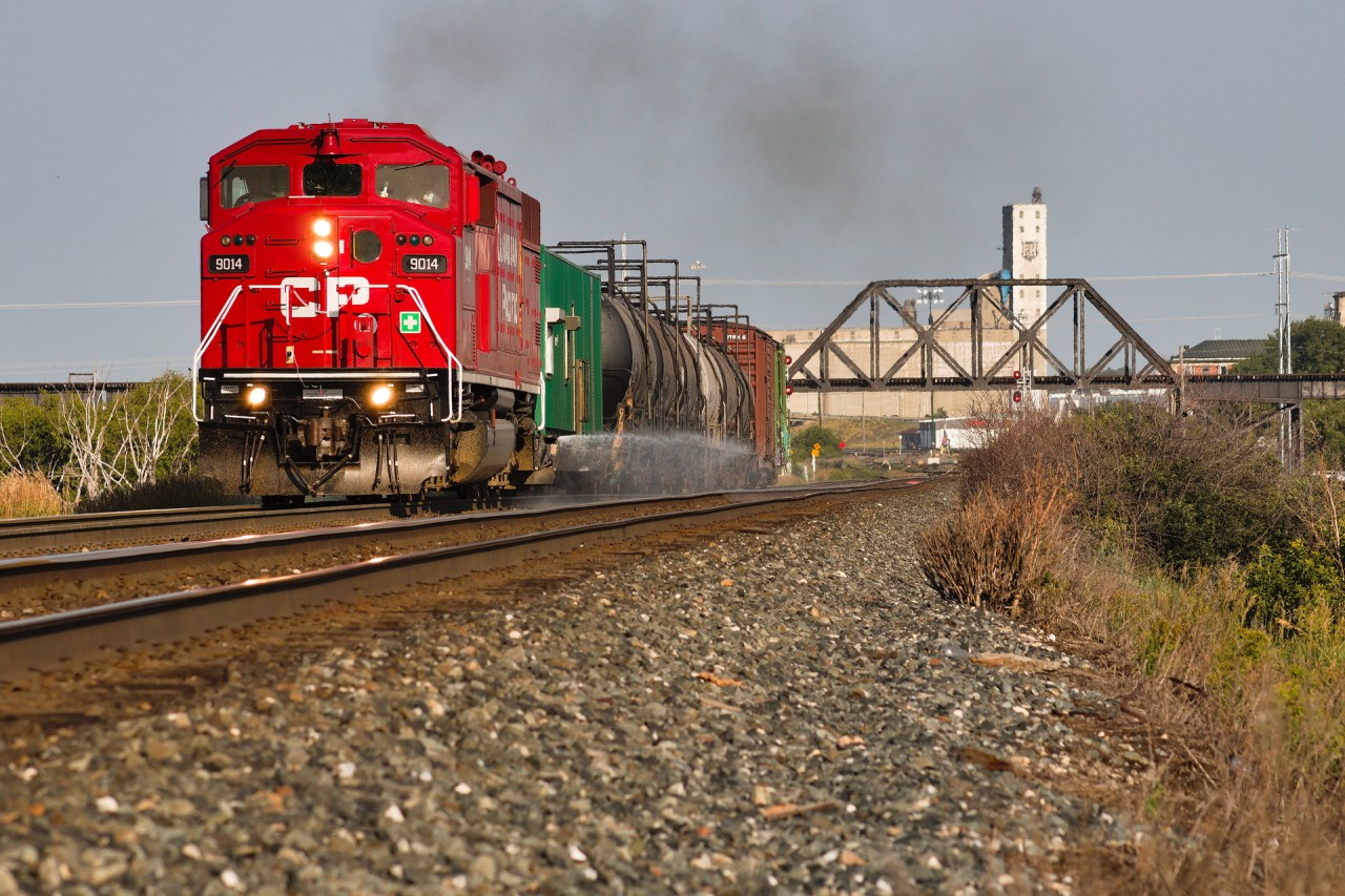 The 2023 sprayer is back for seconds as it retraces its steps through Saskatchewan for some branch line sprayin'. Now wielding the red barn that had been occupied in BC for some time after post-Mayfield repairs were done to it in Ontario, it replaced the Toronto-allocated 5988 somewhere near the west coast to ping-pong it back east. CPKC 2WWE-08 departs Moose Jaw in beautiful low-angled 7am sunlight, for a weekend of spraying the Weyburn Subdivision. Here it clears Moose Jaw East with the ex-CN (Now Southern Rails Co-op) Avonlea Sub bridge overlooking.