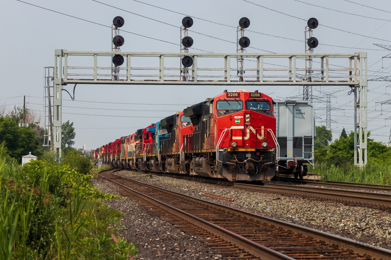 CN M394 ducks under the Snider West signal bridge with 2 ET44ACs and 18 C40-8/M/Ws destined for Toronto. Units included are CN 3206, CN 3269, IC 2462, CN 2019, BCOL 4623, CN 2424, CN 2008, CN 2003, CN 2038, CN 2005, CN 2037, BCOL 4619, CN 2402, CN 2036, CN 2432, BCOL 4620, CN 2431, CN 2434, CN 2444, CN 2180. There are dozens of railfan rumors on what is happening to all of these dash 8s, and I will keep out of the debate, but I will say I am grateful to watch 9 of my favourite units (the C40-8M) again.