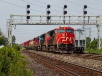 CN M394 ducks under the Snider West signal bridge with 2 ET44ACs and 18 C40-8/M/Ws destined for Toronto. Units included are CN 3206, CN 3269, IC 2462, CN 2019, BCOL 4623, CN 2424, CN 2008, CN 2003, CN 2038, CN 2005, CN 2037, BCOL 4619, CN 2402, CN 2036, CN 2432, BCOL 4620, CN 2431, CN 2434, CN 2444, CN 2180. There are dozens of railfan rumors on what is happening to all of these dash 8s, and I will keep out of the debate, but I will say I am grateful to watch 9 of my favourite units (the C40-8M) again. 