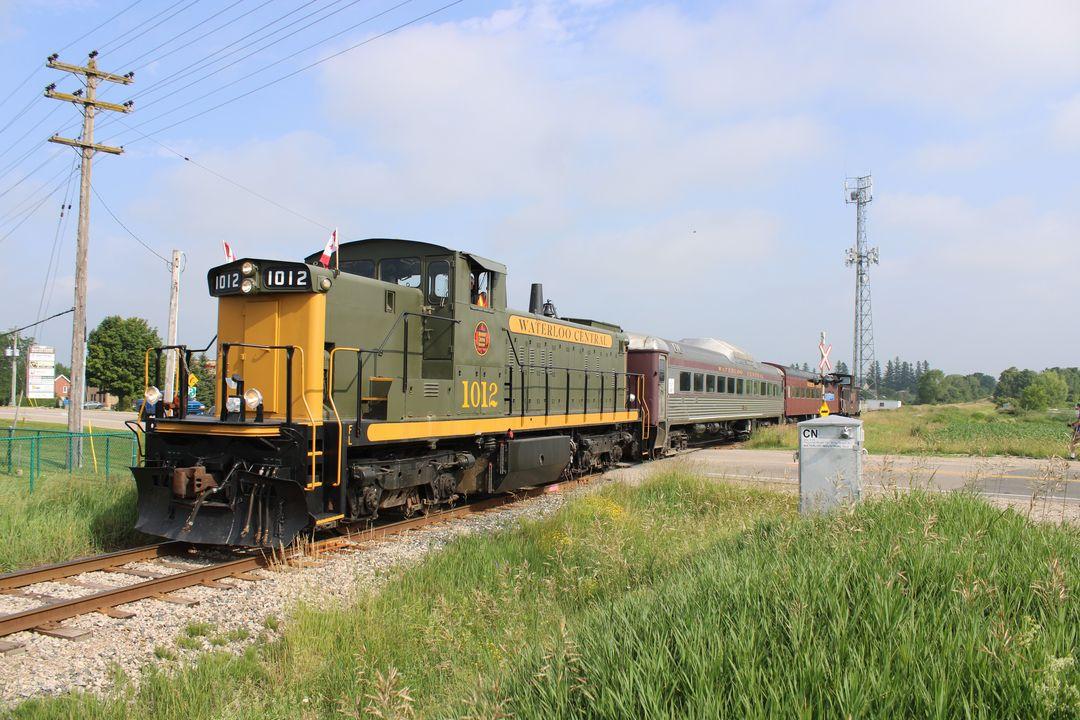 Once CN 1437, we see WCR 1012 leading the first Canada Day train as it is heading to the market. As per the Waterloo Central site, this train was called the Heritage Hopper for the day.