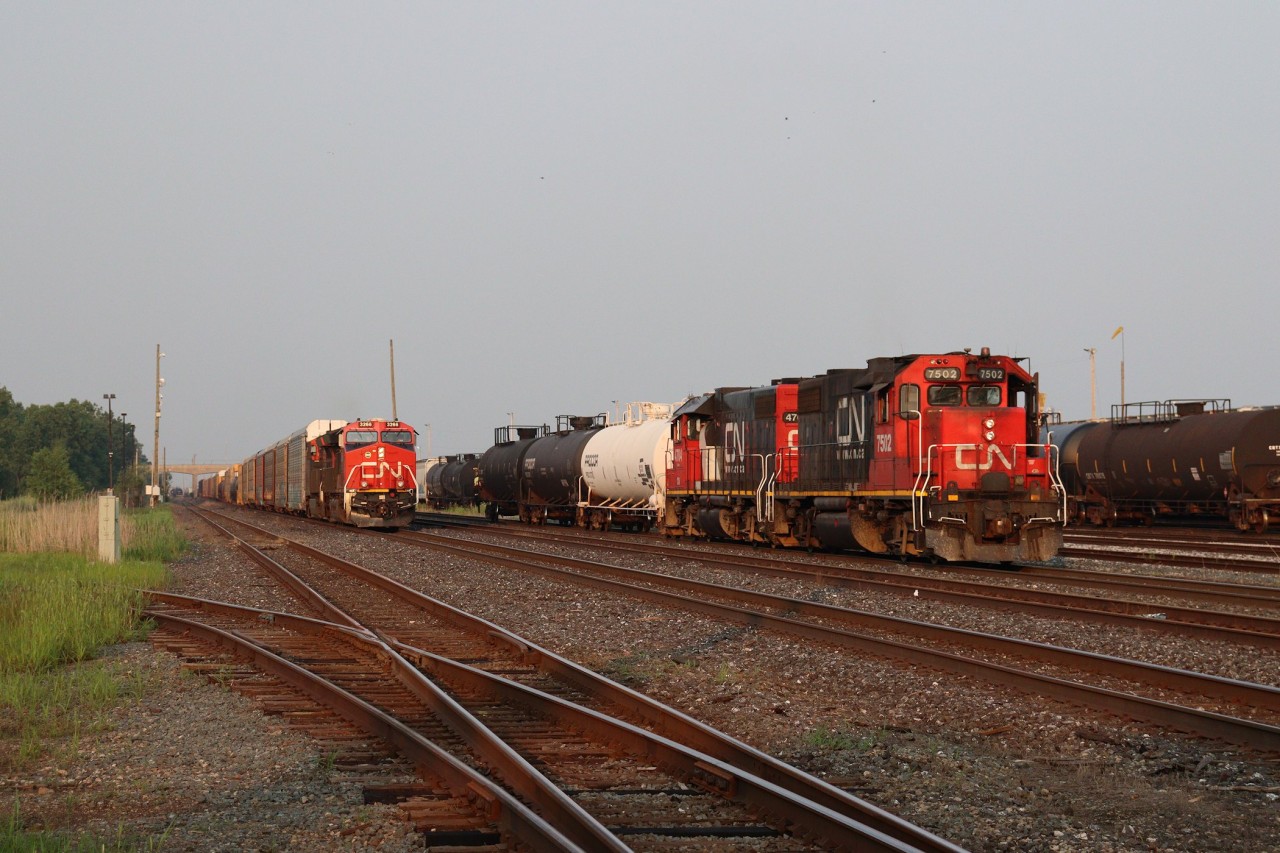 CN's Sarnia "Industrial" assignment shoves three cars back towards the Sarnia "A" classification yard, while the "Puller" crew brings train A491 out of the yard on the South Main to bring it across the border to Port Huron, MI where a US crew will pick it up for the trip westward to Battle Creek.