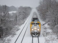 On this freezing Winter day, VIA 73 has just departed London as it heads west along the CN Strathroy Subdivision towards Komoka - about to pass under the well-known wooden Frank Lane bridge.  This spot has always proved to have nice vantage points for the CN line, as well as the CP Windsor Subdivision a few hundred feet to the north.  The telephone poles that still stand here are a welcome sight, as they've been torn down elsewhere along the line in recent years.  
<br>
Leading is VIA 909, built in November of 2001.  The "love the way" wrap that was applied in 2020 is already starting to show wear, as the original renaissance paint can be seen underneath in places.  However, the yellow certainly stands out and makes for a nice burst of color in the winter wonderland that it was that day.  The general consensus among railfans is that these P42DC locomotives will be the first to get retired once the new Siemens trainsets are fully pressed into service.  Get pictures of the older equipment when you see it!