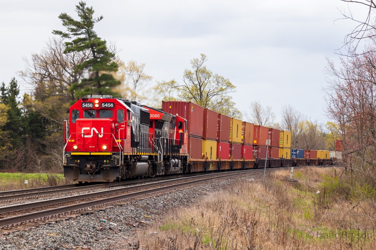 CN SD60s are pretty uncommon in the Greator Toronto Area, and have been for multiple years. CN averages about two every year on the Halton, when they escape local service in the USA. This 148 was power swapped in Flint Michigan, with a SD60/Tevo combo getting put on the hotshot stacker. As a result, a bunch of railfans made their way to the tracks for it. CN 5456 and CN 3060 approach SNS Stewarttown with lights all the way to Brampton.