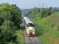 It's just after eight o'clock in the morning and I'm standing on the Jones Baseline bridge and it's not the safest place to wait for a train but when one of the few remaining EMD F59PH locomotives in GO 562 leads, you do what you have to do. Here, it climbs the grade leaving Guelph through the haze of the wild fire smoke on its way east for its next stop at Acton. I've saw this eight o'clock train many times but lately it's been running with the solo F59PH up front where in the past, it has had two locomotives up front with the standard cab car on the rear.