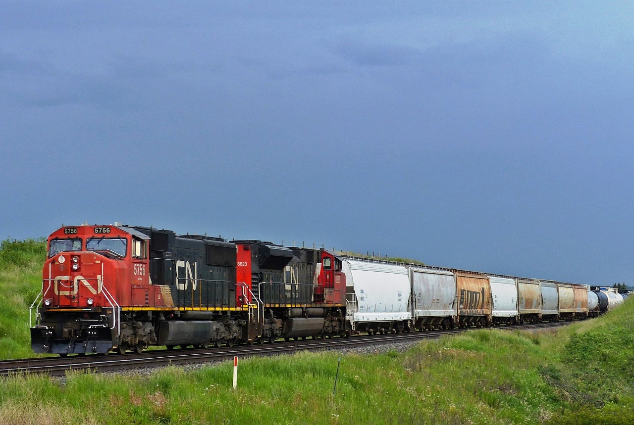 Waiting on the mainline near Fabyan, Alberta just east of the Battle River Railway Trestle (also known as the Fabyan Trestle Bridge) are CN 5756 and CN 8823.