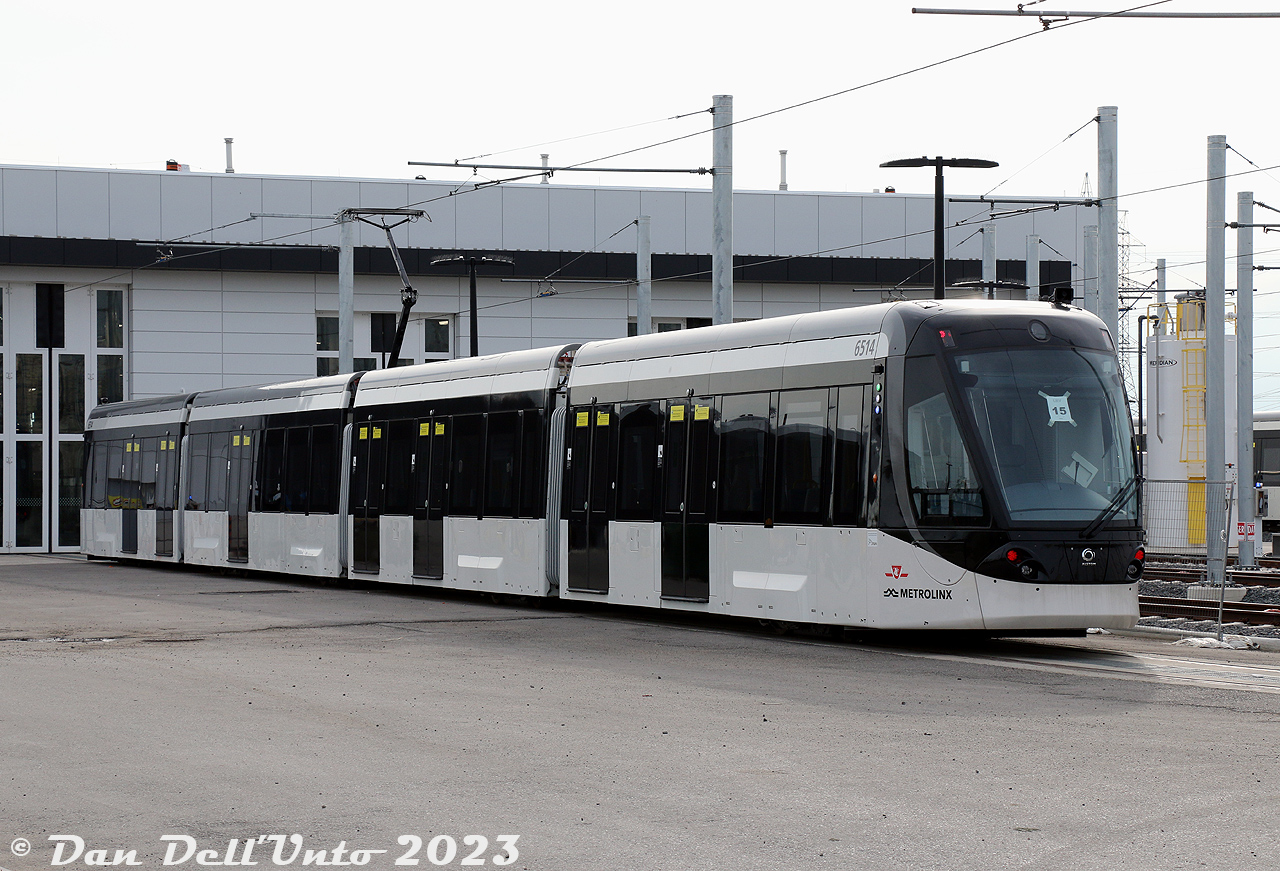 Finch West meets the Future: TTC 6514, a brand new Alstom Citadis Spirit LRV, sits inside the new Finch West Maintenance and Storage Facility in the North York area of Toronto. The "15" taped inside its front window denotes this as the 15th car of the order of 18 (6500-6517). The small fleet of 4-car articulated sets are owned by Metrolinx and are to be operated by the TTC on the nearby yet-to-be-opened Finch West LRT line (currently undergoing testing in some parts, and construction in others). These are different from the LRVs to be used on the Eglinton LRT line: the 6200-series Bombardier Flexity Freedom units.* Note, photo taken from public property outside with a very convenient telephoto lens.